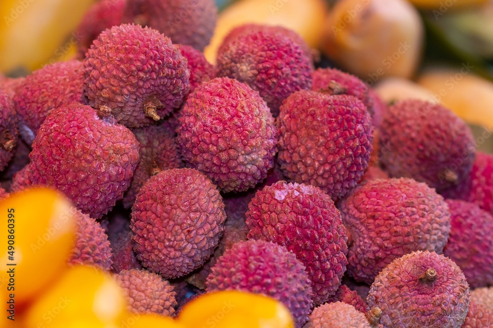 Lychee (Litchi chinensis) background, close-up macro in a market in Beijing (China). Lychee (Litchi chinensis) background, close-up macro in a market in Beijing (China).