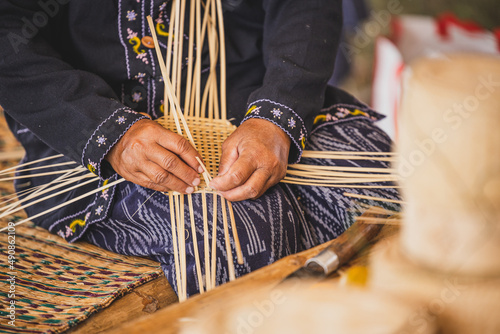 Photography Asian hilltribe woman handcraft weaving bamboo stripe for basket or tray