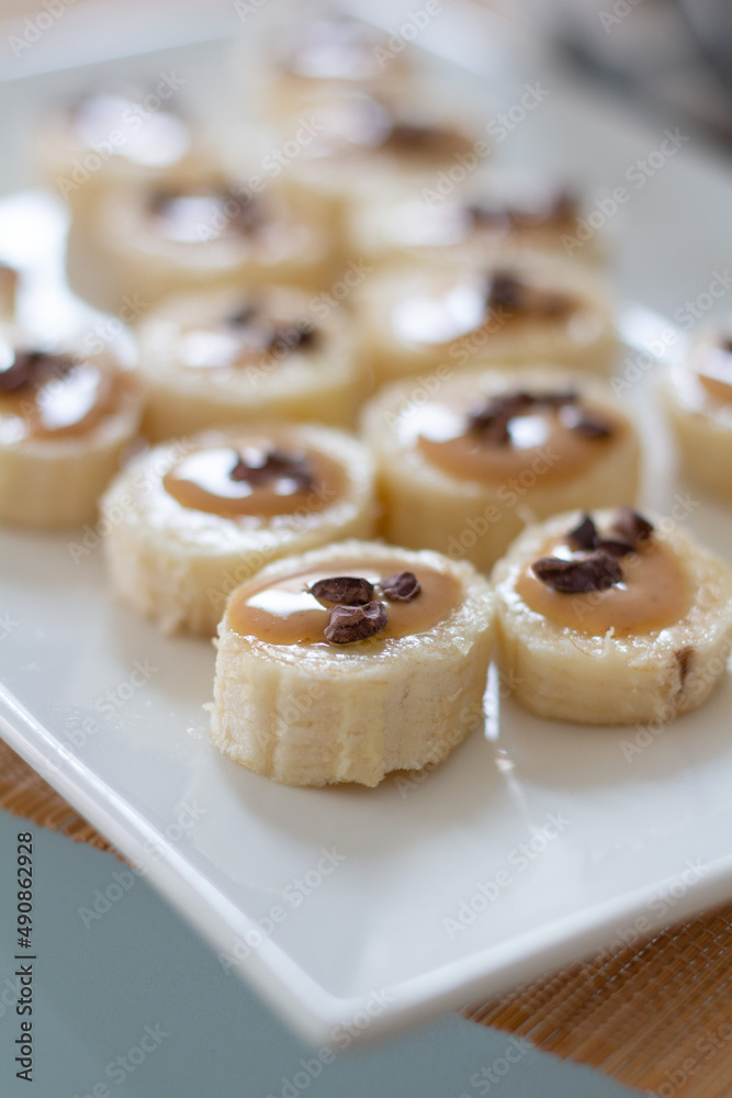 Fast homemade snack: banana canape with cacao nibs, Peanut butter and coffee. Delicious, healthy food Fast homemade snack: banana canape with cacao nibs, Peanut butter and coffee. Delicious, healthy food