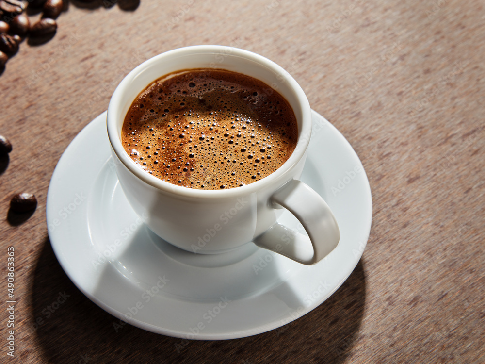 Fototapeta premium Coffee cup and beans on a dark background.