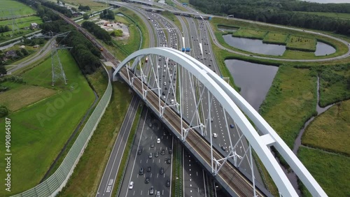 Aerial view of the Zandhazenbrug is railway bridge with the longest span in the Netherlands located near Amsterdam and Muiderberg over the A1 motorway and part of the train line Weesp to Lelystad 4k