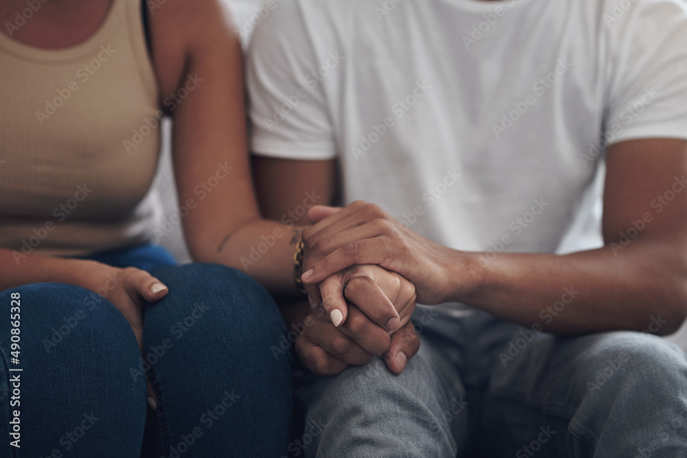 Well work through this together. Cropped shot of an unrecognizable couple sitting inside together and holding hands. Well work through this together. Cropped shot of an unrecognizable couple sitting inside together and holding hands.