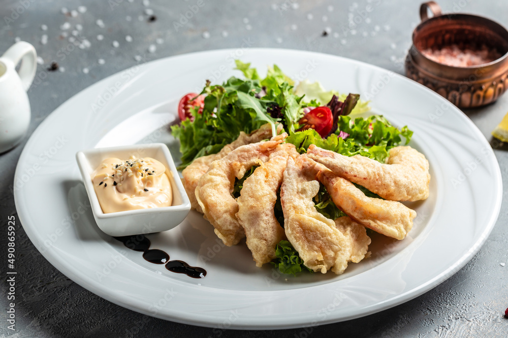 Shrimp fried in batter and sauce with salad. Healthy food, keto diet, diet lunch concept Shrimp fried in batter and sauce with salad. Healthy food, keto diet, diet lunch concept