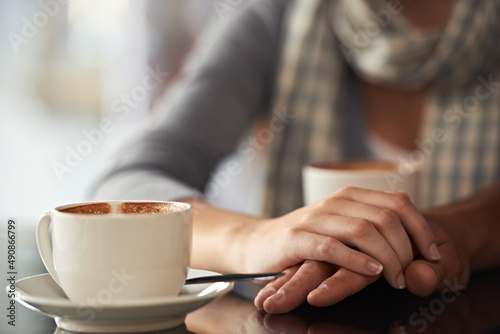 Enjoying a coffee shop date. Cropped shot of a couple sitting in a coffee shop. © Mikolette Moller/peopleimages.com