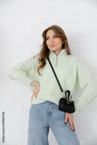 The smallest women's handbag. a fashionable women's accessory. clutch bag with gold hardware. Fine black leather handbag. 