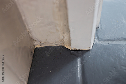 close up of tile flooring and architrave with old worn out materials in need to be fixed, diy and home improvements