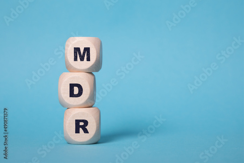 MDR Acronym on wooden blocks isolated on bluebackground, copy space.
