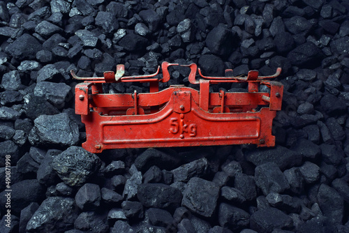 Red weight showed on coal of mine deposit mineral resources background