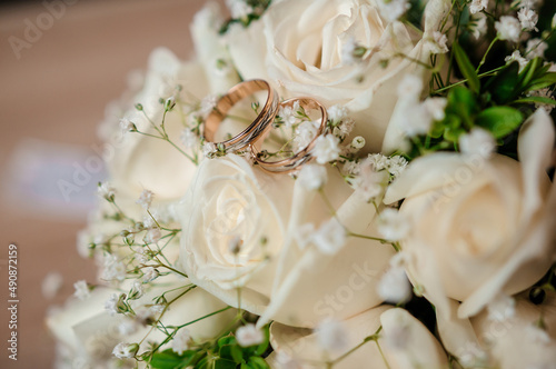 Beautiful bridal bouquet of flowers. Wedding rings on the bride's bouquet. Bridal bouquet close up