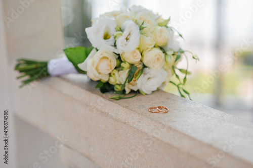 Beautiful bridal bouquet of flowers. Wedding rings on the bride's bouquet. Bridal bouquet close up
