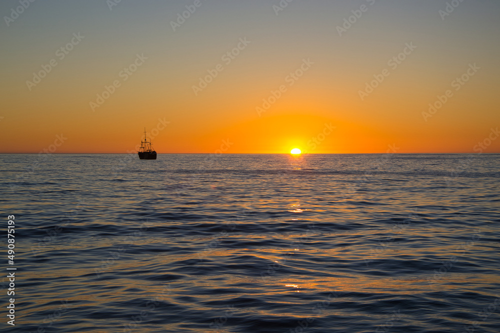 Boat trip towards sunset on Atlantic Ocean near Cape Town