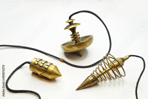 Metal dowsing pendulums  on a white background. photo