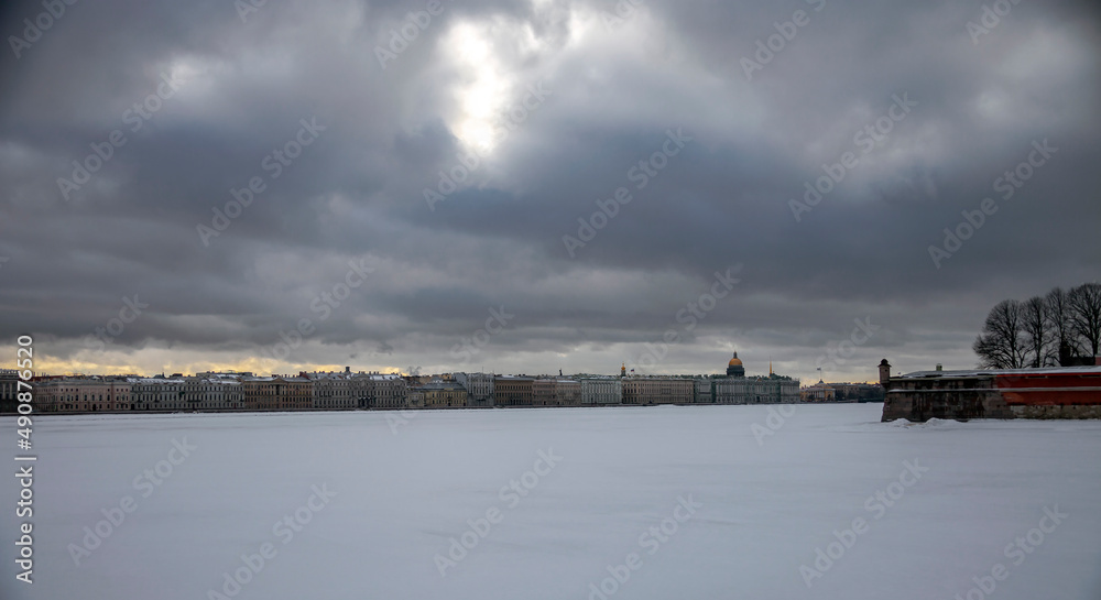 Landscape with winter heavy gray sky over the Palace Embankment in Saint Petersburg.