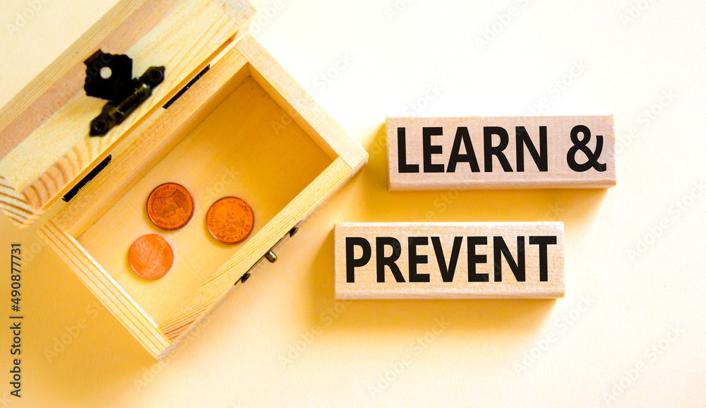 Learn and prevent symbol. Concept words Learn and prevent on wooden blocks on beautiful white background. Wooden chest with coins. Business learning and learn and prevent concept, copy space. Learn and prevent symbol. Concept words Learn and prevent on wooden blocks on beautiful white background. Wooden chest with coins. Business learning and learn and prevent concept, copy space.