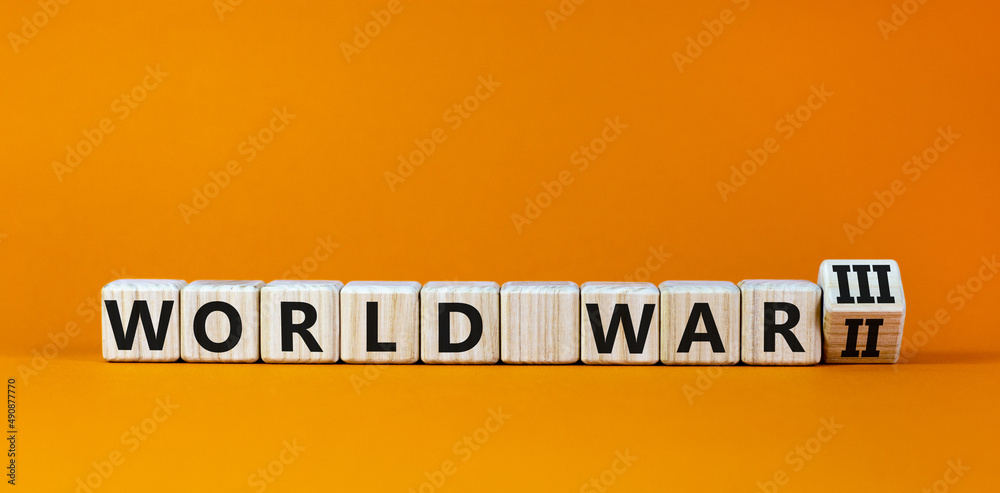 WW3 world war 3 symbol. Turned the wooden cube and changed the concept word World War 2 to World War 3. Beautiful orange table orange background, copy space. Business WW3 world war 3 concept. WW3 world war 3 symbol. Turned the wooden cube and changed the concept word World War 2 to World War 3. Beautiful orange table orange background, copy space. Business WW3 world war 3 concept.