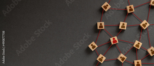 Organization structure, social network and teamwork concept on dark background. Business people icon on wooden cube blocks connecting network of connections. photo