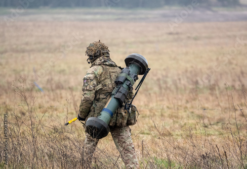British army soldier completing an 8 mile combat fitness test tabbing exercise with fully loaded 25Kg bergen and NLAW (MBT-LAW, RB-57) anti-tank guided missile