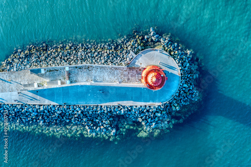 Obraz na płótnie Aerial view of Poolbeg Lighthouse the famous red landmark in Dublin Harbor Ireland seen by drone at sunset w salonie