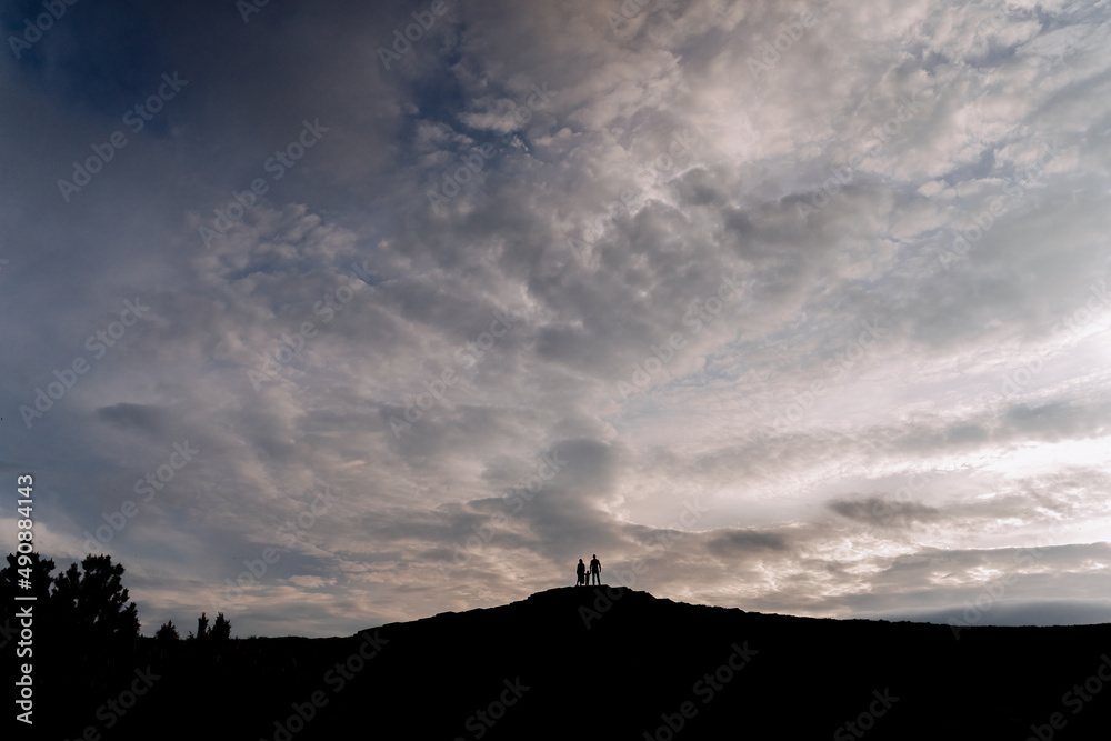People Silhouettes Standing on Hill Photography