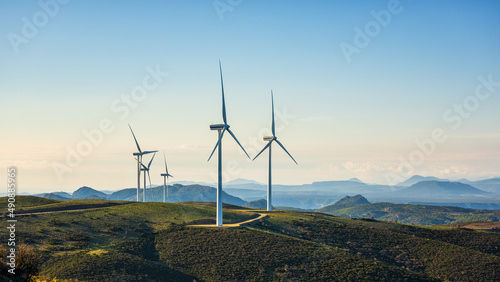 Turbines in a mountain wind farm. Ecological energy production. photo