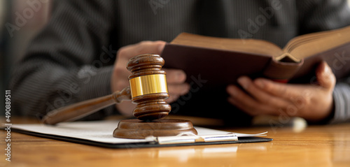 The judge s hammer is placed on the table  the lawyer concept assumes that the defendant defends the client in order to win the case or gain the greatest benefit in accordance with the law.