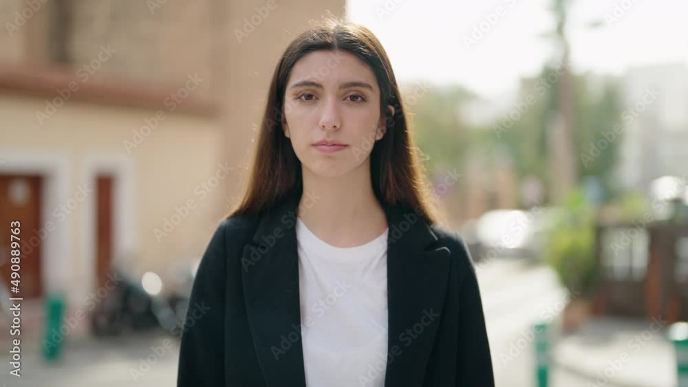 Young hispanic girl smiling confident standing at street