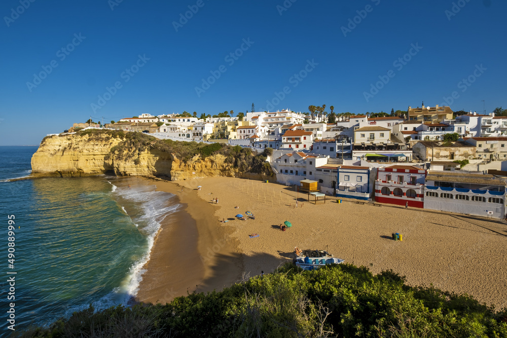 Townscape of Carvoeiro Sandy beach between cliffs and white architecture, Algarve, Portugal