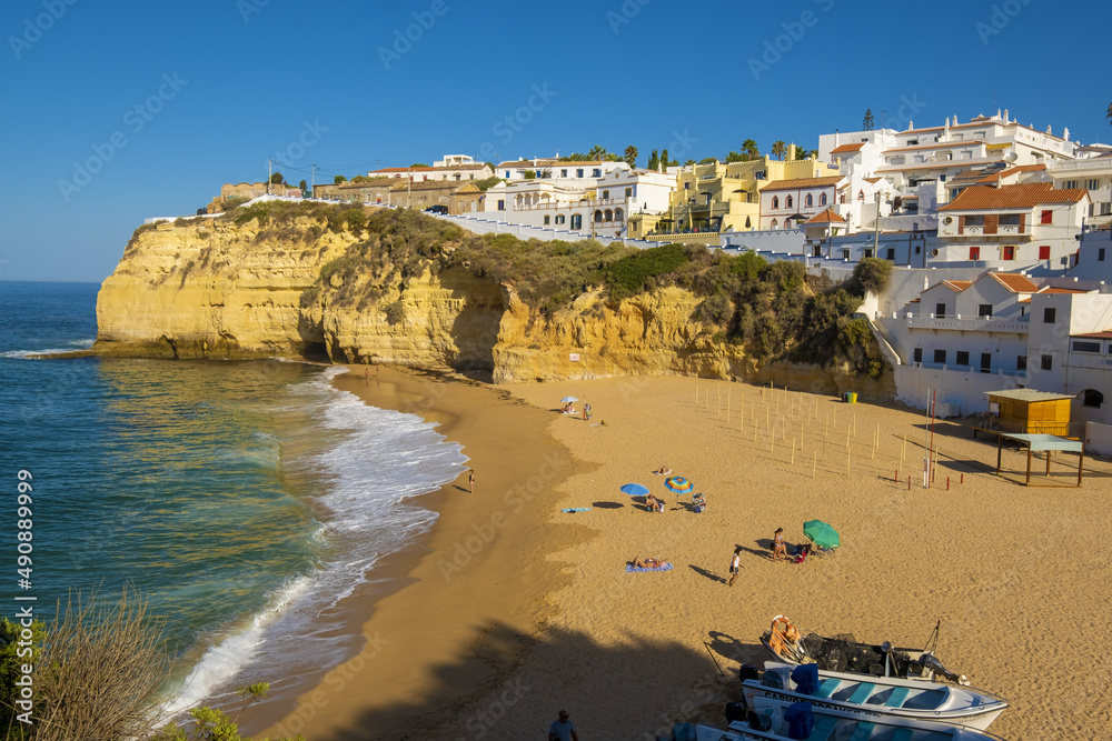Townscape of Carvoeiro Sandy beach between cliffs and white architecture, Algarve, Portugal
