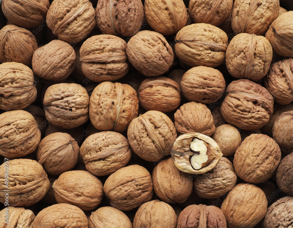 Dried whole and cracked walnuts in a heap, healthy food also an addition to dishes .... Dried whole and cracked walnuts in a heap, healthy food also an addition to dishes ....