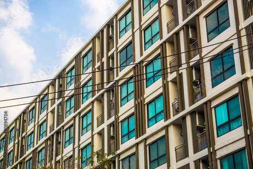 Modern condominium window building against blue sky city resident