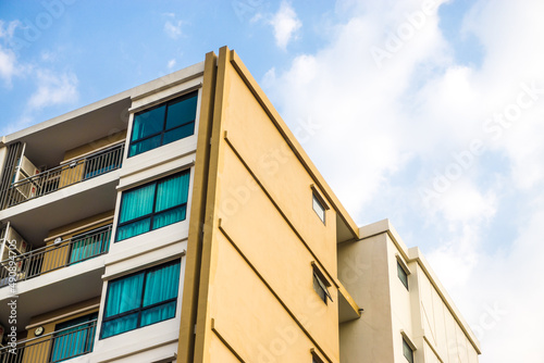 Modern condominium window building against blue sky city resident