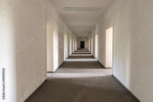 Old abandoned and run-down hallway of a theater  with light filtering through the doors