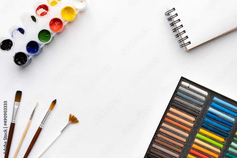 Flat composition set of artistic tools. Brushes, paints, pencils, pastels for drawing. Place for text. Flat composition set of artistic tools. Brushes, paints, pencils, pastels for drawing. Place for text.