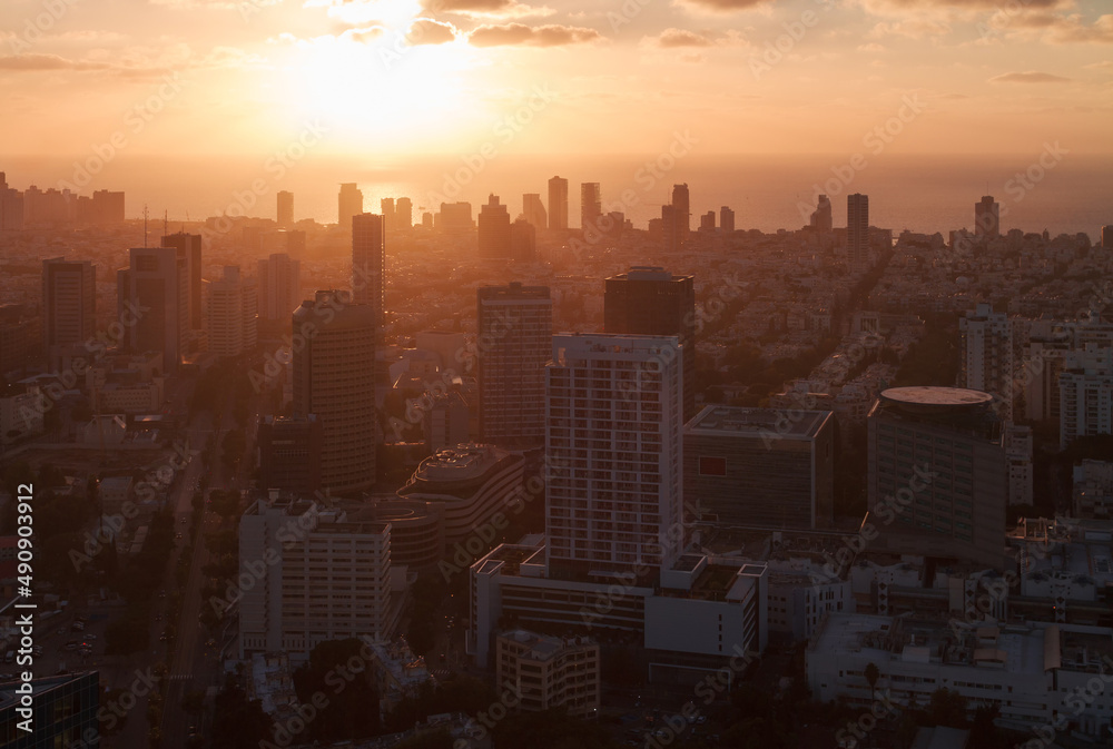 Orange sunset in Tel Aviv city. Aerial view above