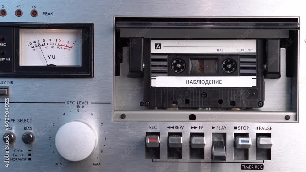 Audio Cassette Tape in Deck Player With Russian Surveillance Recording Close Up Audio Cassette Tape in Deck Player With Russian Surveillance Recording Close Up