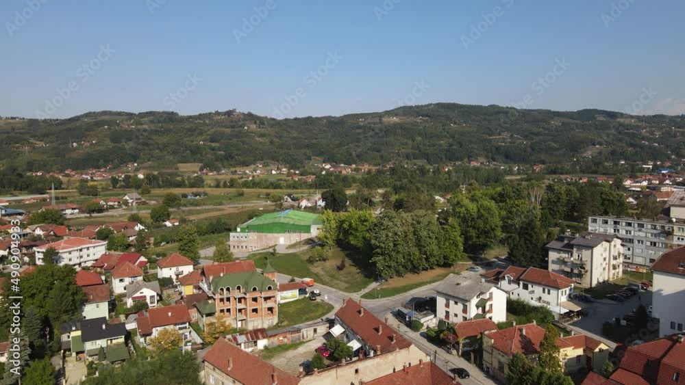 Arilje, Serbia. Aerial View of Green Landscape and Suburban Buildings on Sunny Summer Day - Drone Shot Arilje, Serbia. Aerial View of Green Landscape and Suburban Buildings on Sunny Summer Day - Drone Shot