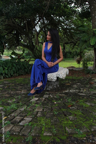 Beautiful girl in a long blue dress. A young woman of Asian descent with black hair