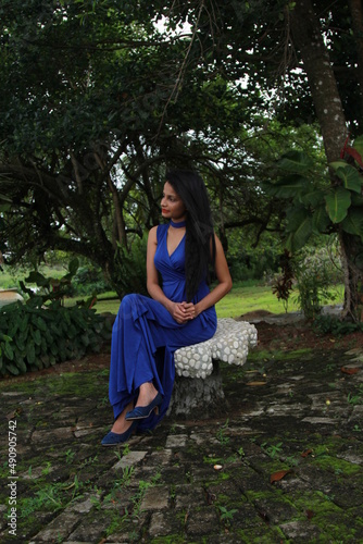 Beautiful girl in a long blue dress. A young woman of Asian descent with black hair