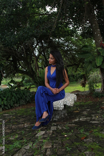 Beautiful girl in a long blue dress. A young woman of Asian descent with black hair