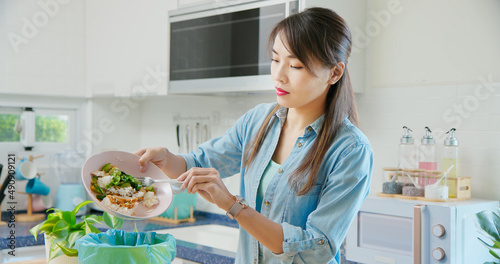 woman is scraping food leftovers photo