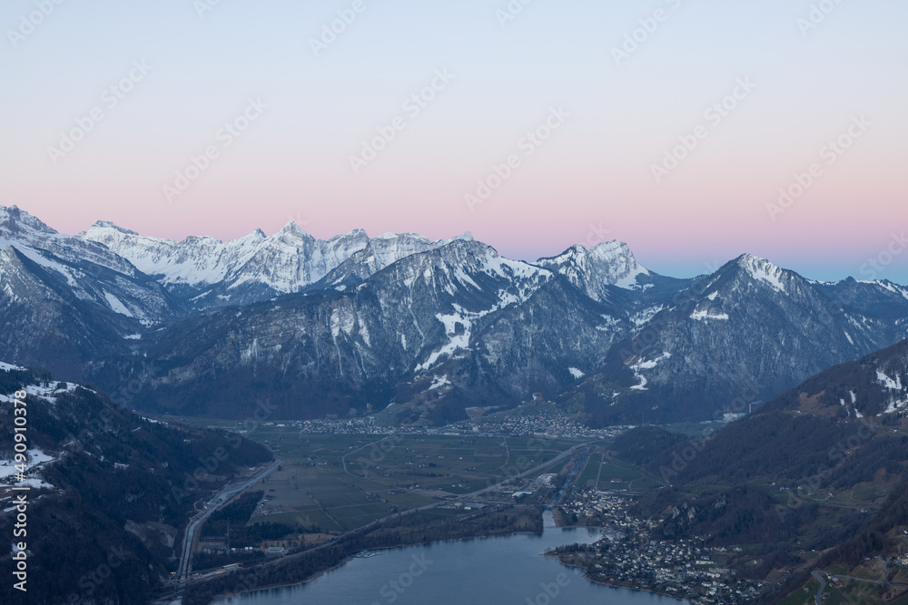 What a wonderful sunrise in the Swiss Alps, in the canton of Glarus to be exact. The sky turns red and pink over the mountain peaks.