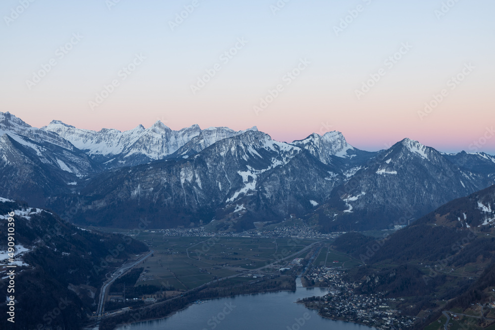 What a wonderful sunrise in the Swiss Alps, in the canton of Glarus to be exact. The sky turns red and pink over the mountain peaks.