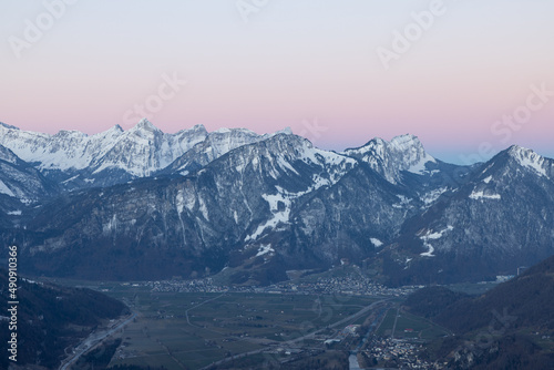 What a wonderful sunrise in the Swiss Alps, in the canton of Glarus to be exact. The sky turns red and pink over the mountain peaks.