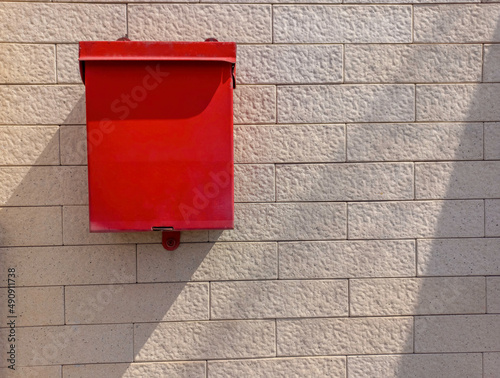 Red mailbox on the wall, outdoor