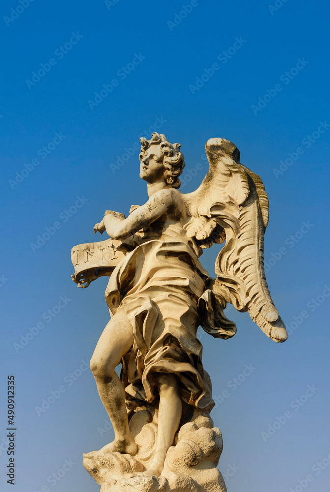 Rome, Italy - June 2000: A stone statue of an angel on a blue sky background