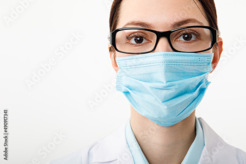 Portrait of a female doctor in a medical mask on a white background
