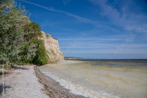 Bank of the Volga River. The surf line, the high shore and the water muddy with limestone.