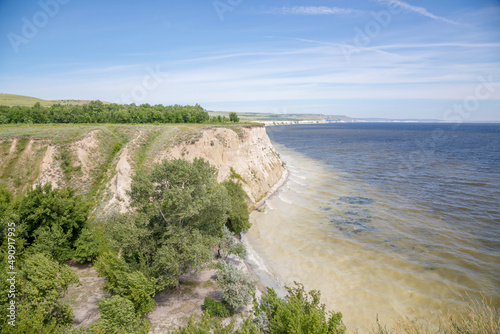 View of the ravines and the high bank of a full-flowing river. Europe  summer.