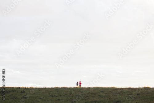 parent and child walking on the road
