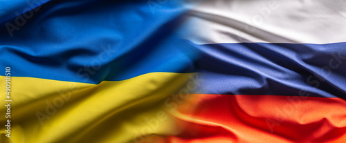 Obraz na plátně Ukrainian and Russian flags next to each other blending into one